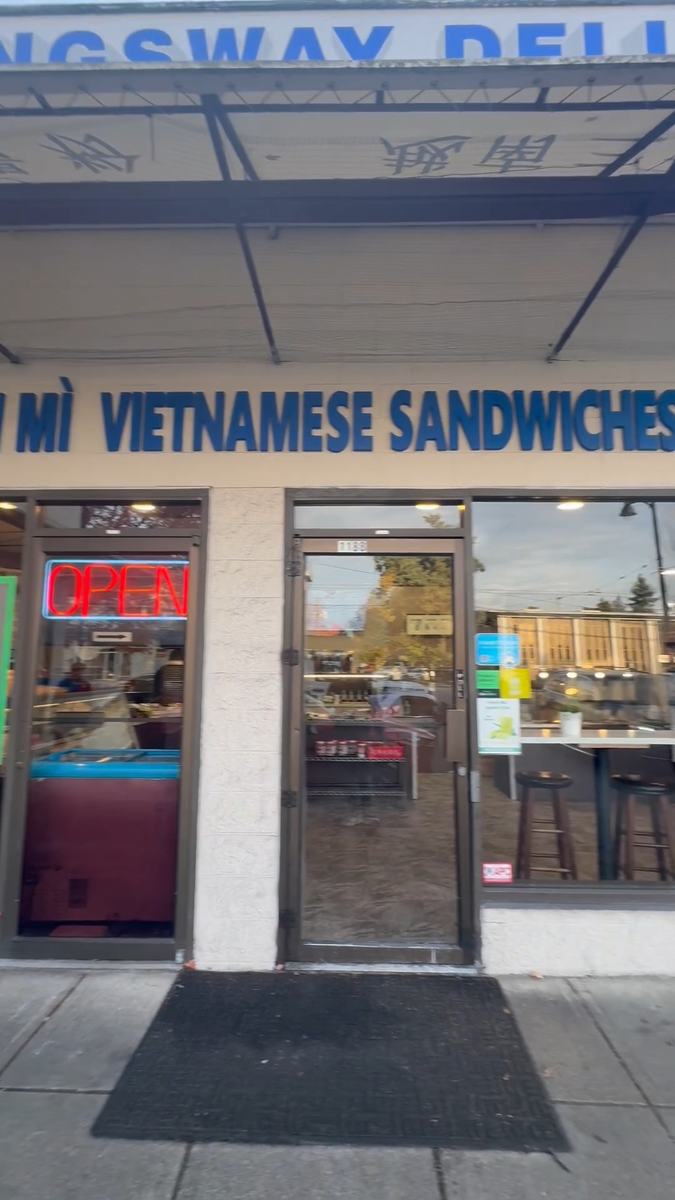 The Kingsway Deli storefront in Vancouver with clean glass across the door and front windows