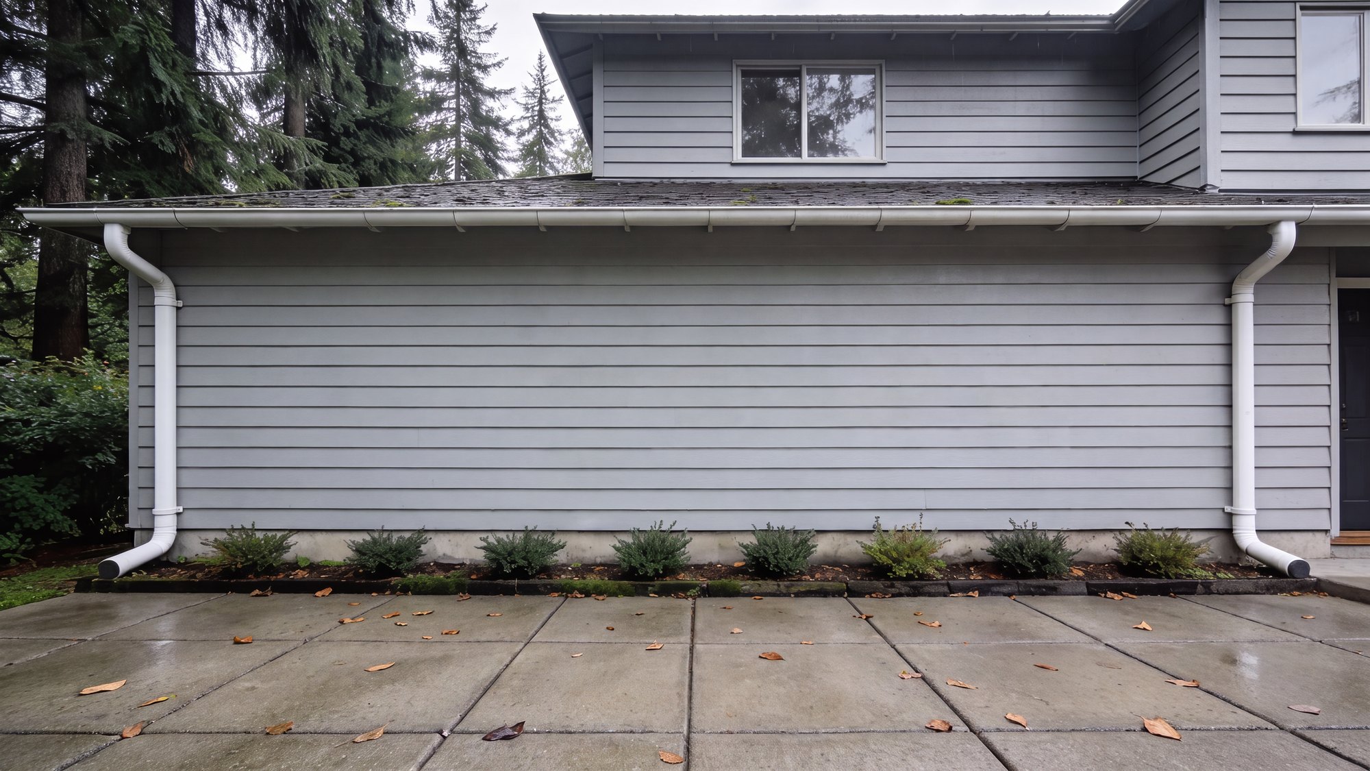 The same wall and paver driveway with the algae, moss and staining washed off
